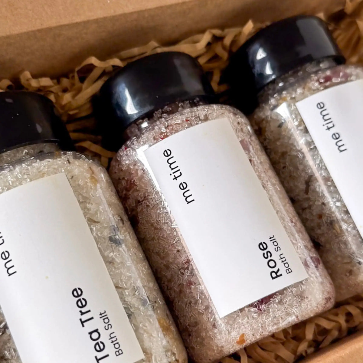 Close-up of mineral bath salts with dried flowers and essential oils