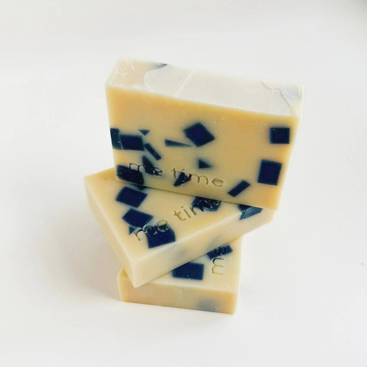 Minimalist product photo of Indigo & Patchouli natural soap on pale grey background – natural skincare UAE.