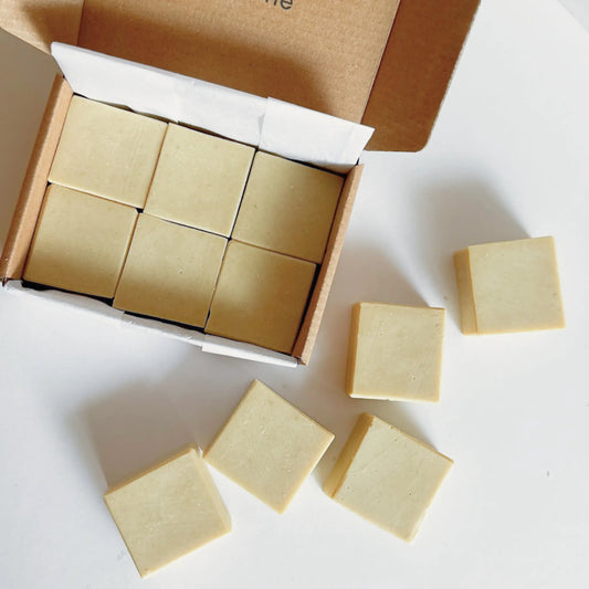 Set of six baby soap mini bars arranged on soft neutral background, highlighting pastel colors, artisan handmade style.