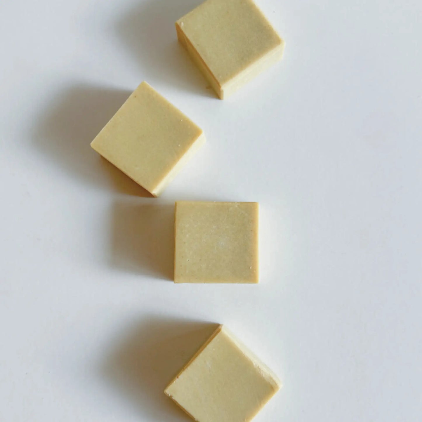 Set of six baby soap mini bars in minimal eco-friendly packaging, soft natural background, premium natural feel.