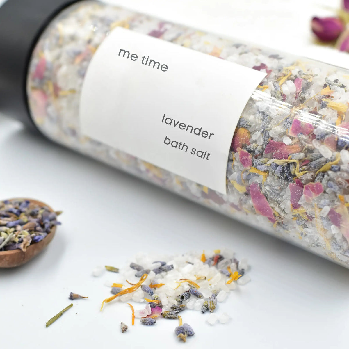 Bottle of lavender bath salts with a label on a white surface