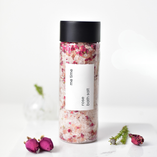 Close-up of rose bath salt showing coarse salt crystals and rose petals.
