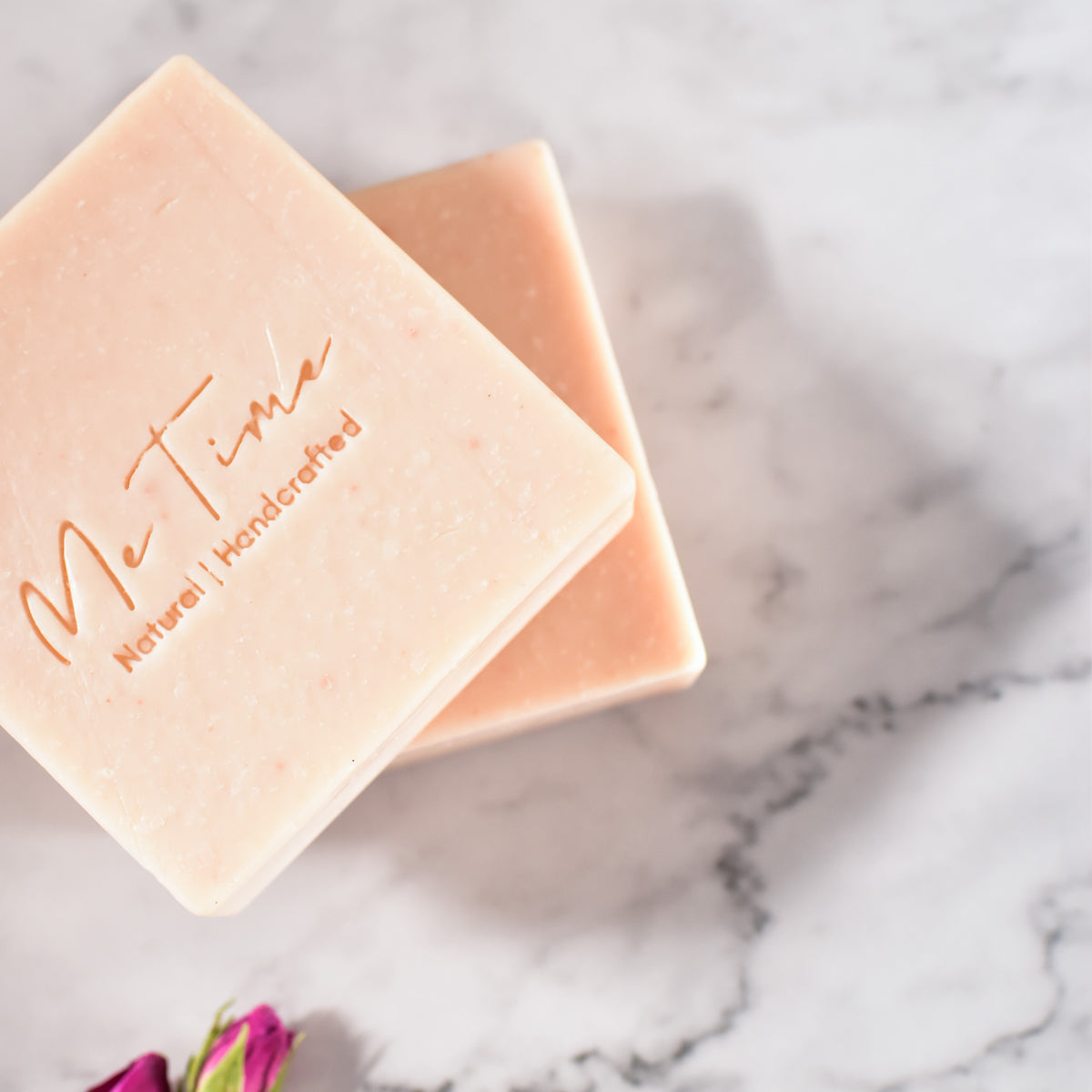 Handmade unscented rose soap bar with soft pink clay tone, crafted with natural oils and butters, on a neutral background.