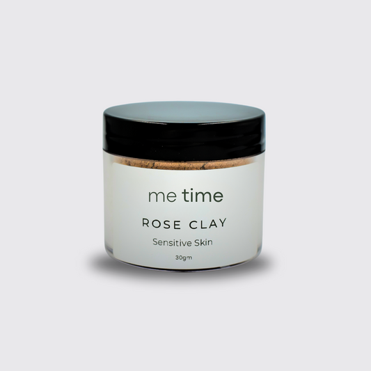 Rose Clay Dry Face Mask in a glass jar with its soft pink powder visible.