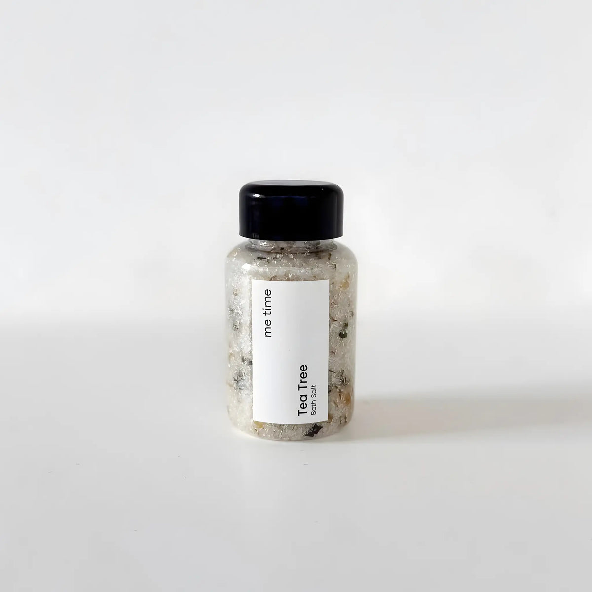 Bottle of 'Tea Tree' product with a black cap on a white background