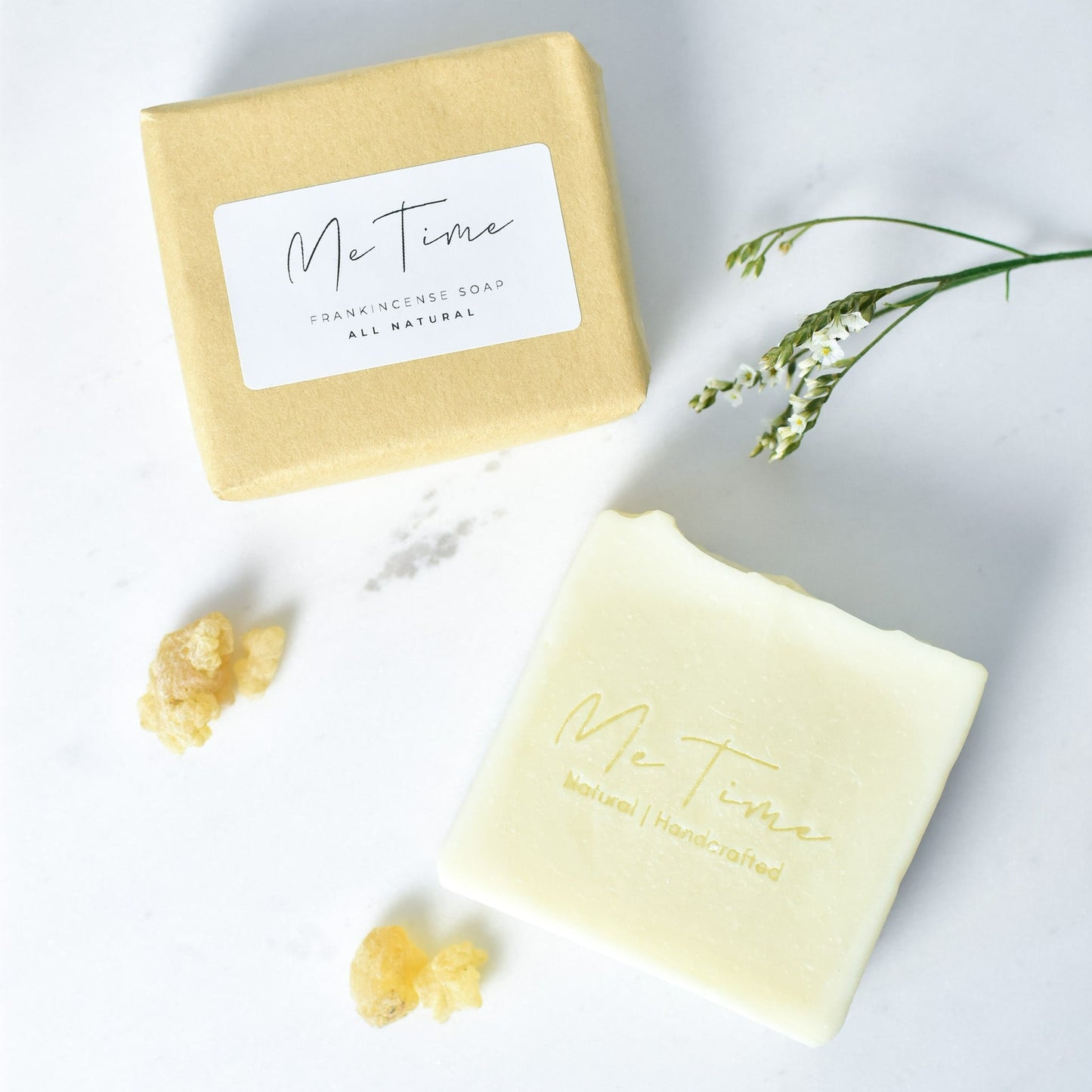 Handmade frankincense soap bar with subtle white clay tones and natural oils, photographed on a neutral background.
