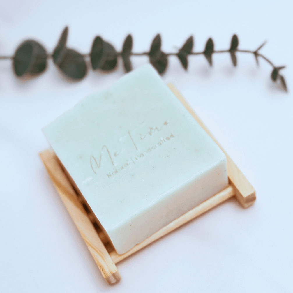 Eco-friendly bamboo soap dish holding a bar of all-natural soap, elegantly designed to keep your soap dry and prolong its life.