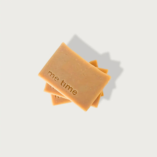 Two bars of Camel Milk soap with 'me time' text on a light gray background