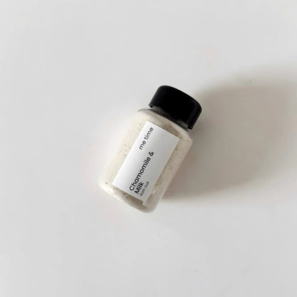 Bottle of Chamomile & Milk product with a black cap on a white background