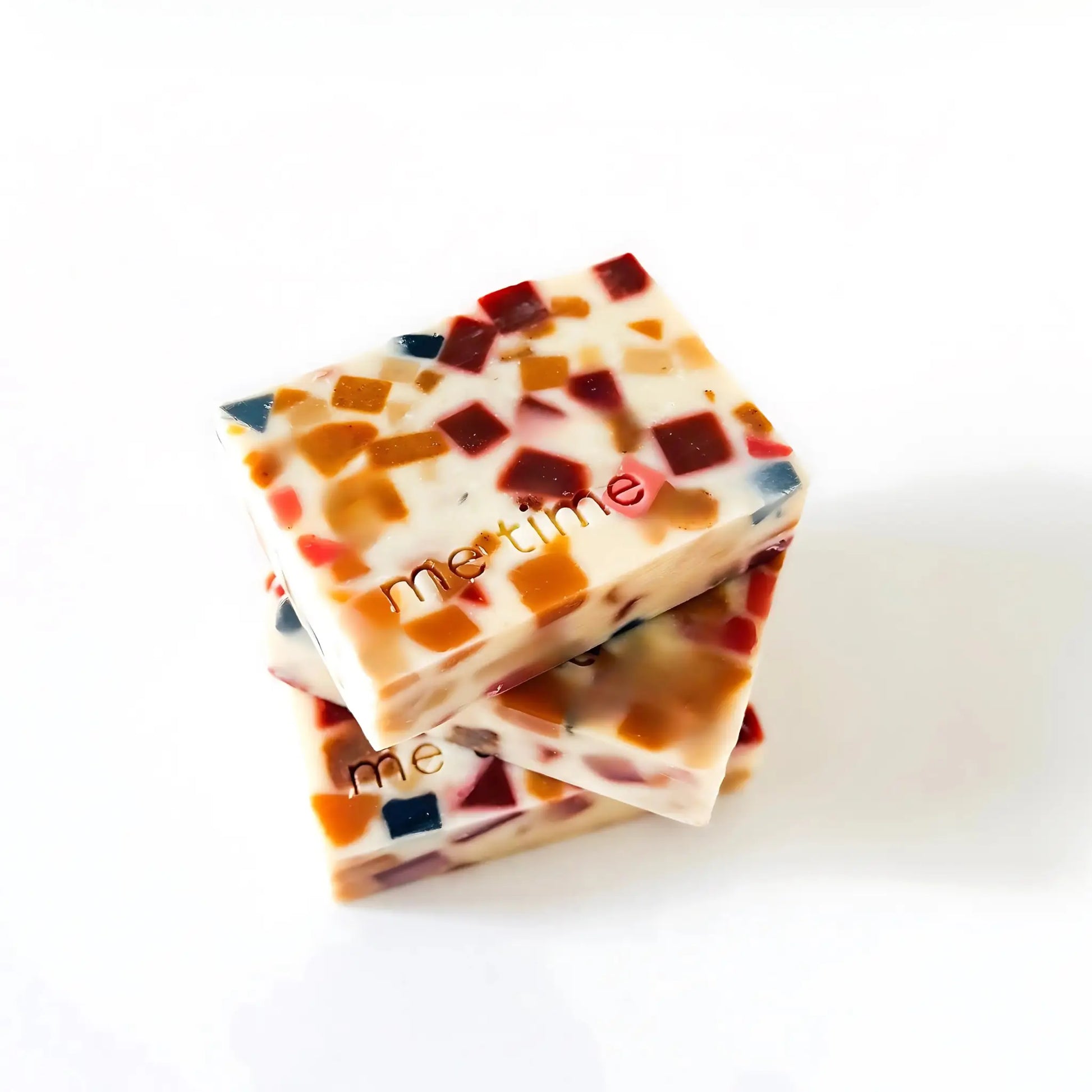 Soap bar on a neutral, soft background, highlighting smooth texture, warm citrus and woody tones.