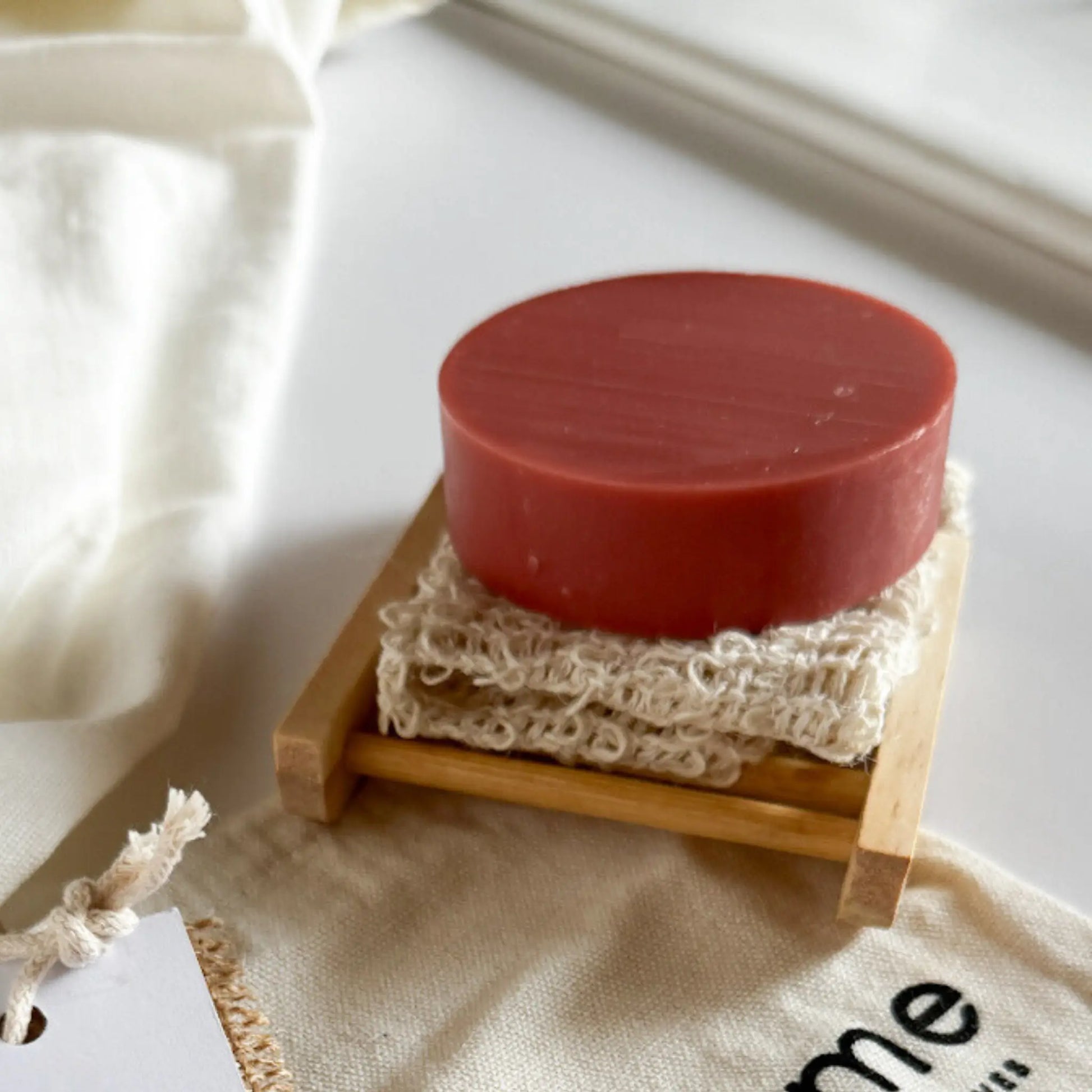 all occasion eco-friendly gift bundle with pink clay soap, exfoliating pouch, bamboo soap dish, and cotton drawstring bag