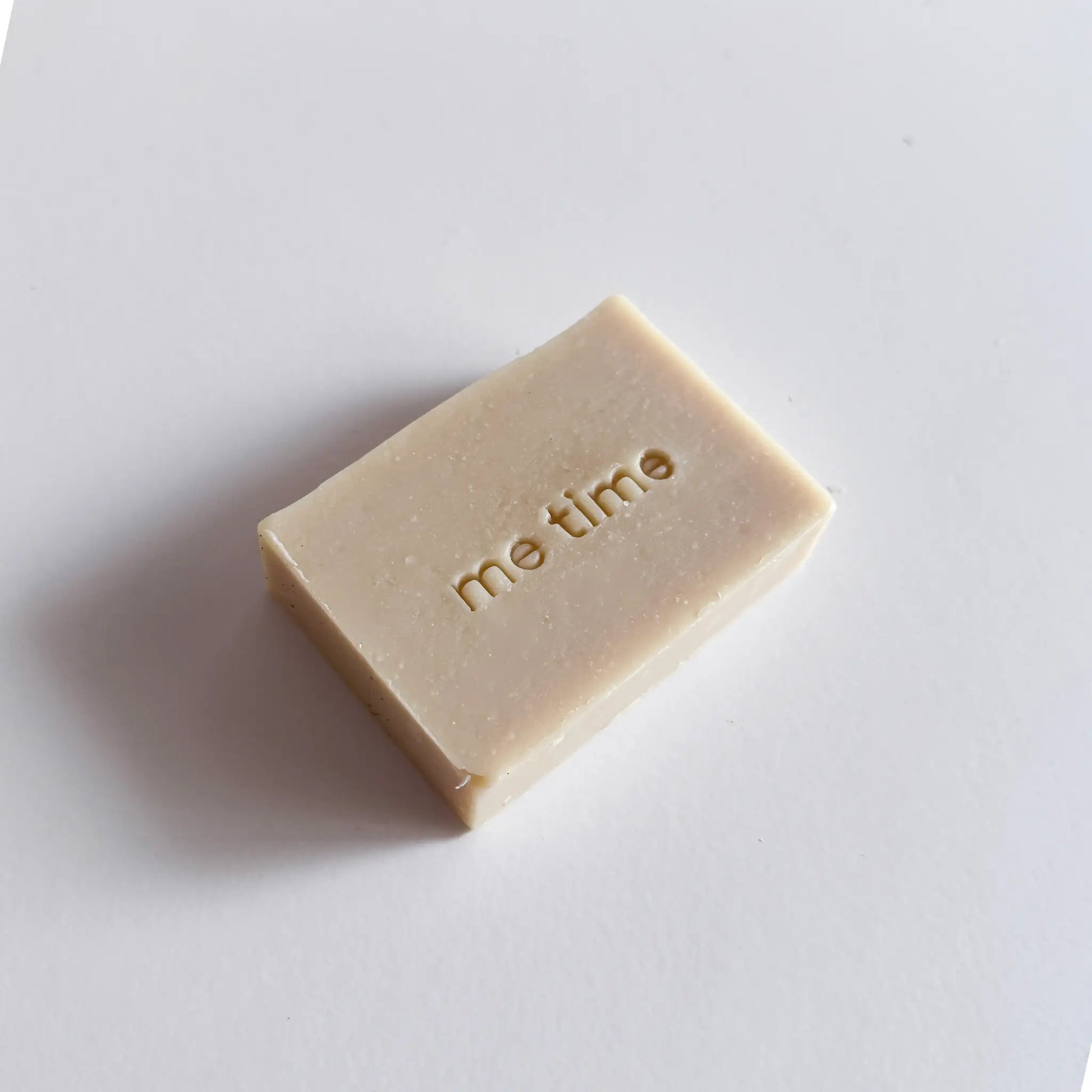 Bar of soap with 'me time' text on a white background