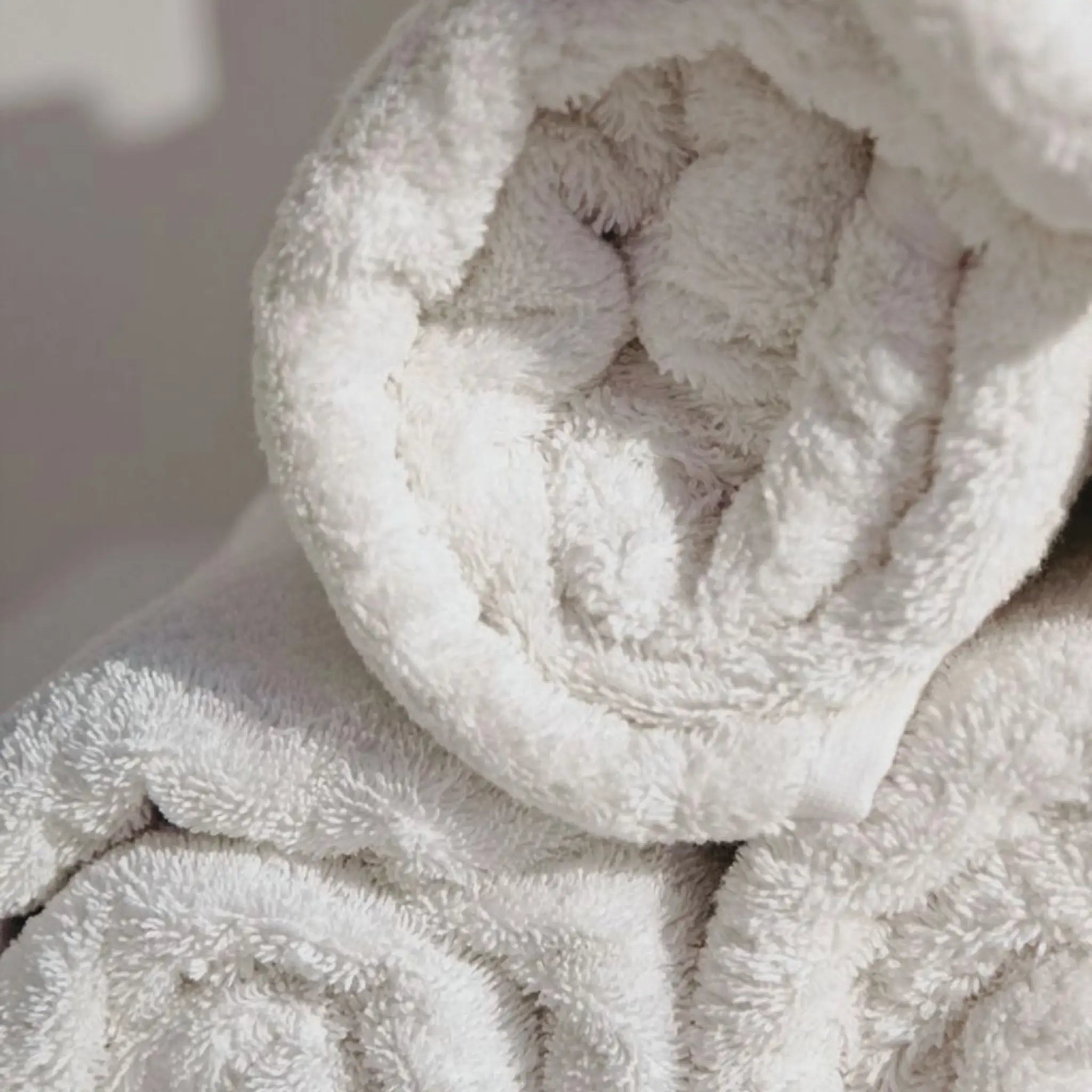 A close-up of me time face cotton towel, 100% cotton towel, showing its soft, textured surface and rolled edges.