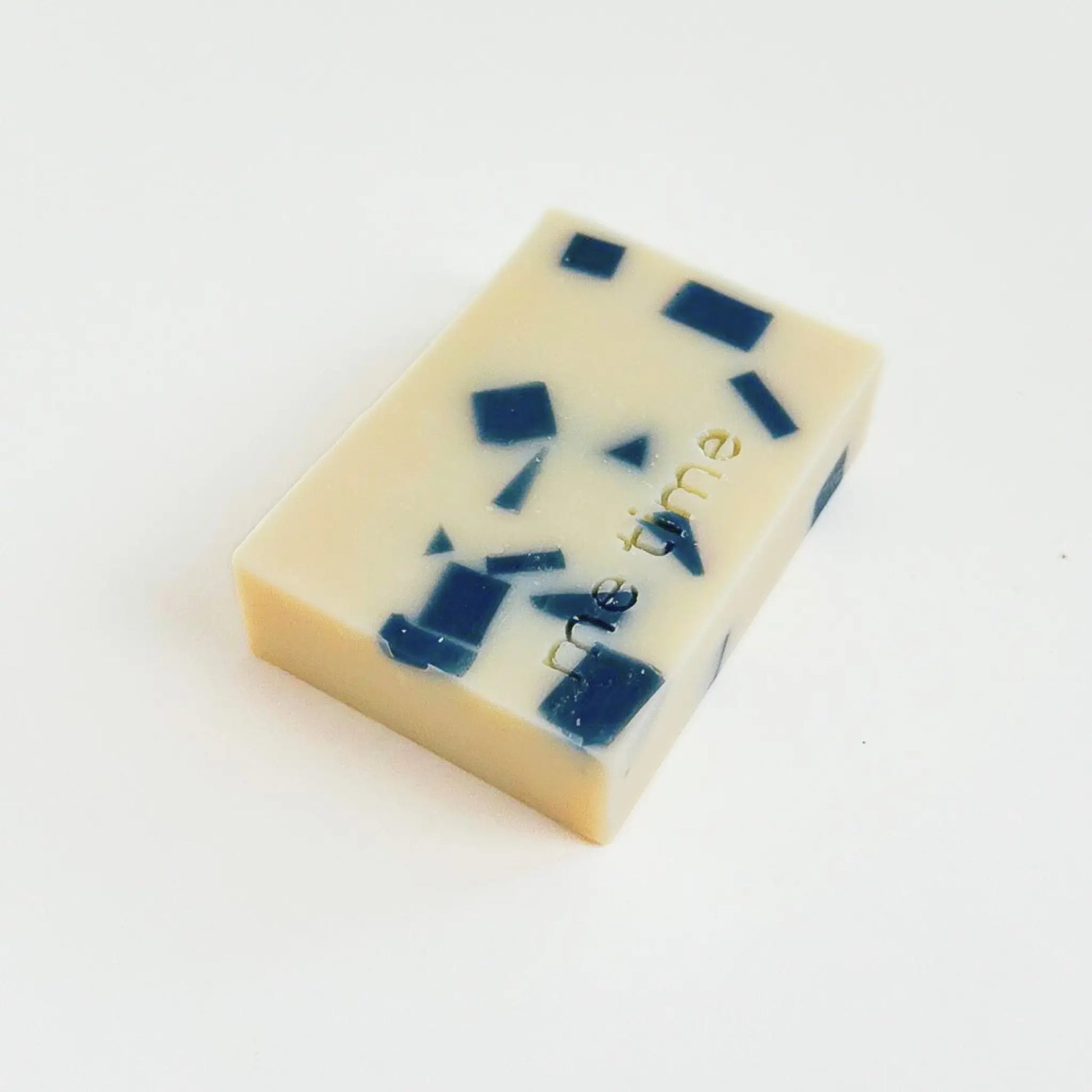 Luxury mosaic cold process soap bar with kaolin clay, navy blue accents, and creamy base – photographed in natural light.