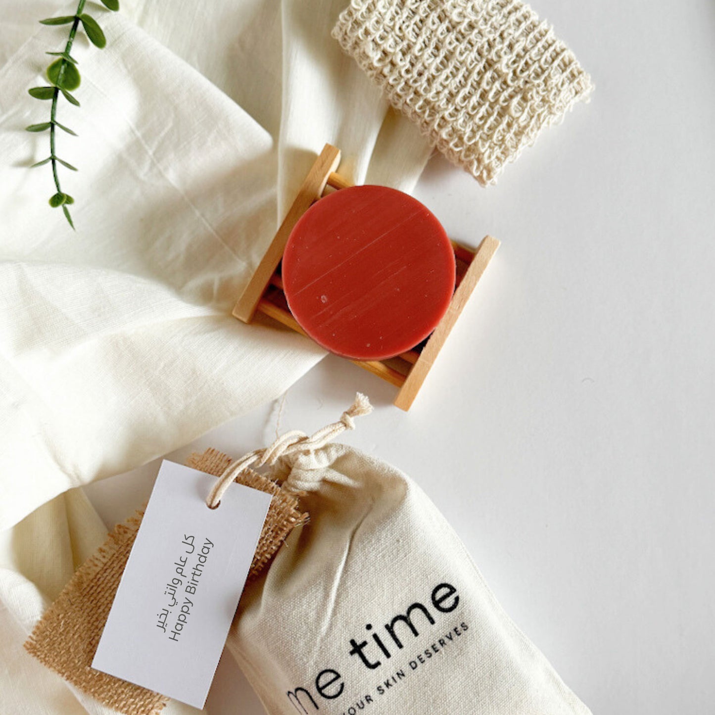 all occasion eco-friendly gift bundle with pink clay soap, exfoliating pouch, bamboo soap dish, and cotton drawstring bag