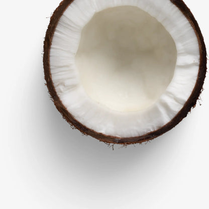 Close-up of a halved coconut on a white background, me time soaps, UAE