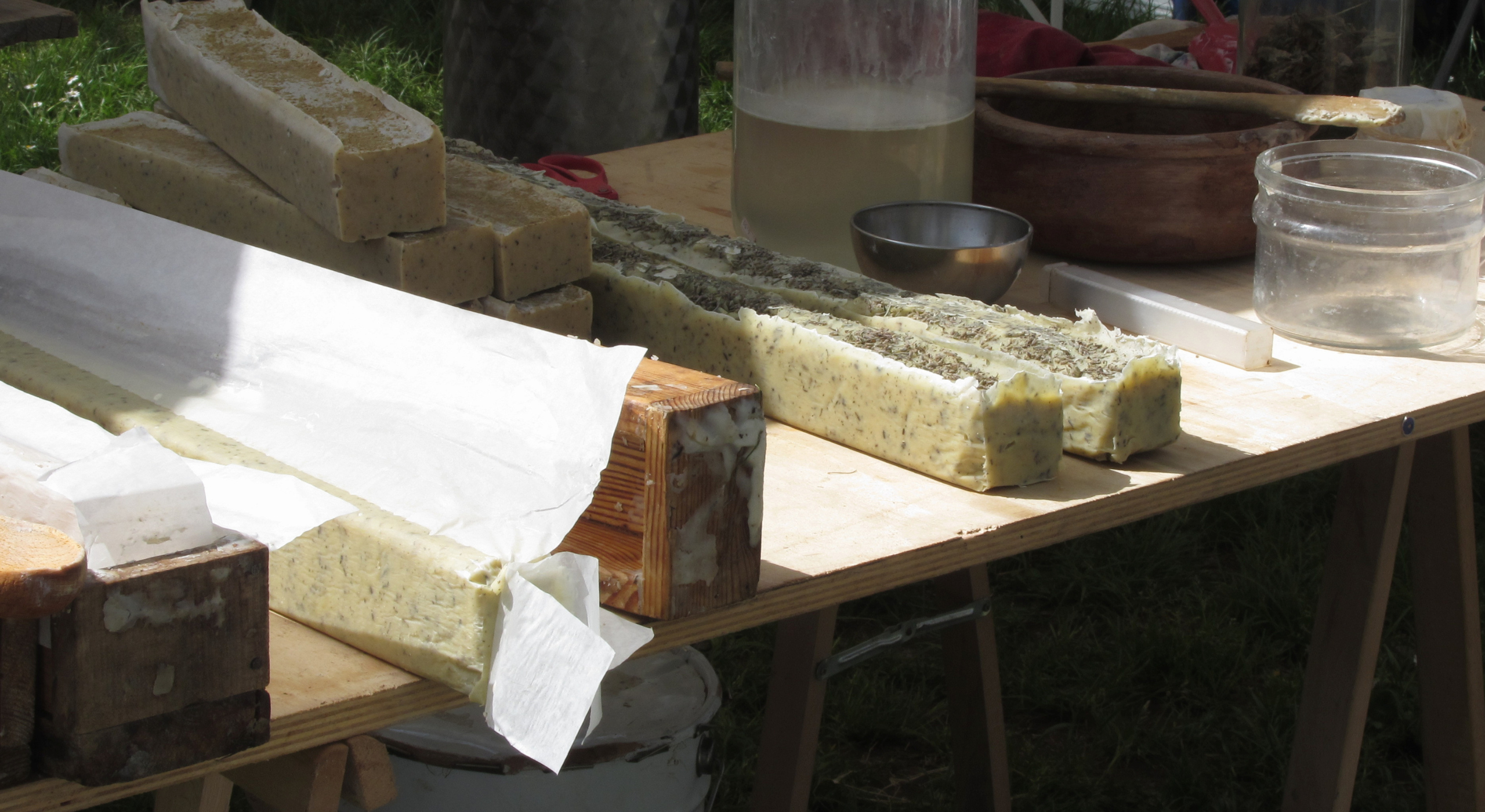 Handcrafted soap batches and wood molds on workshop table at Me Time