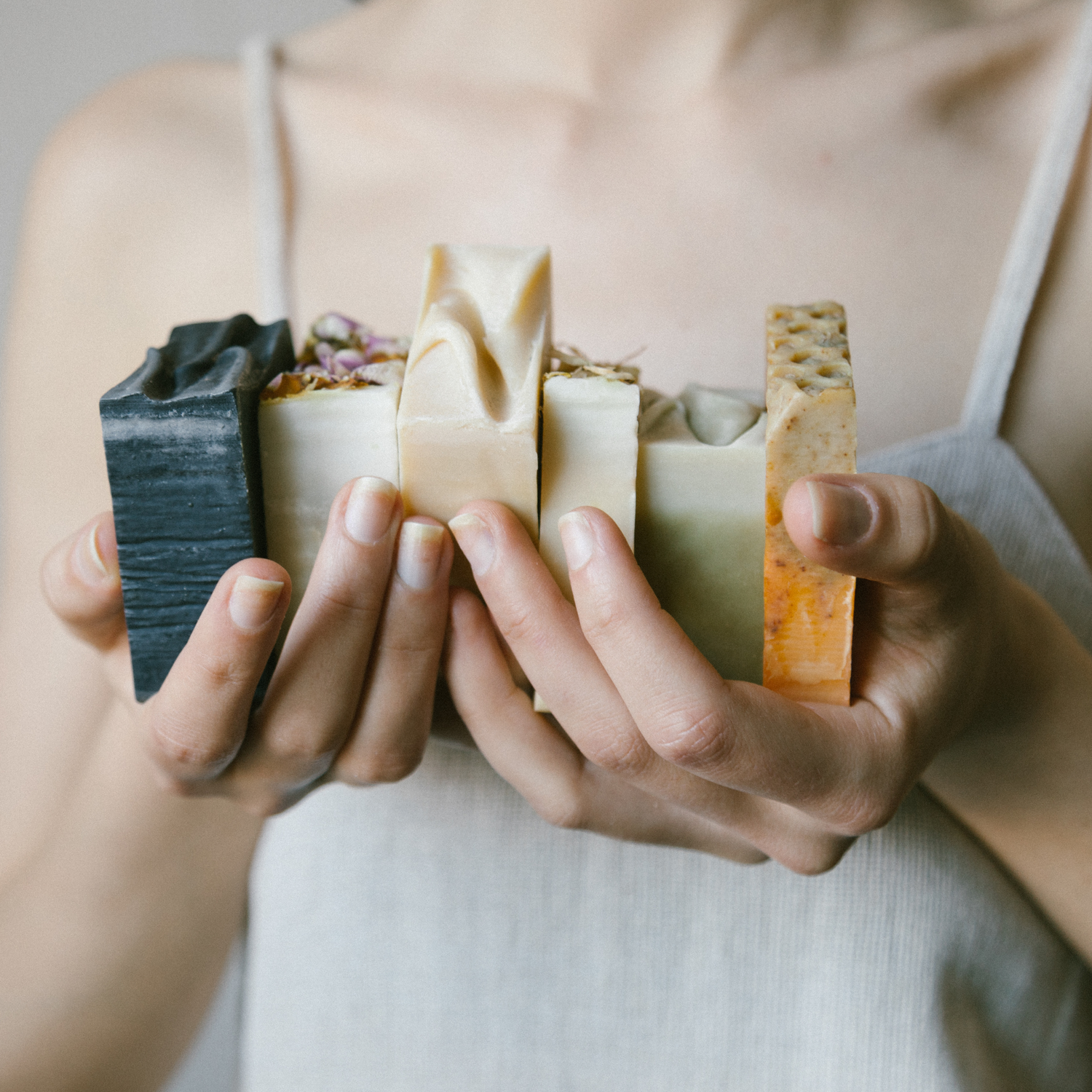 Woman's hands holding natural soap bars by Me Time Skincare