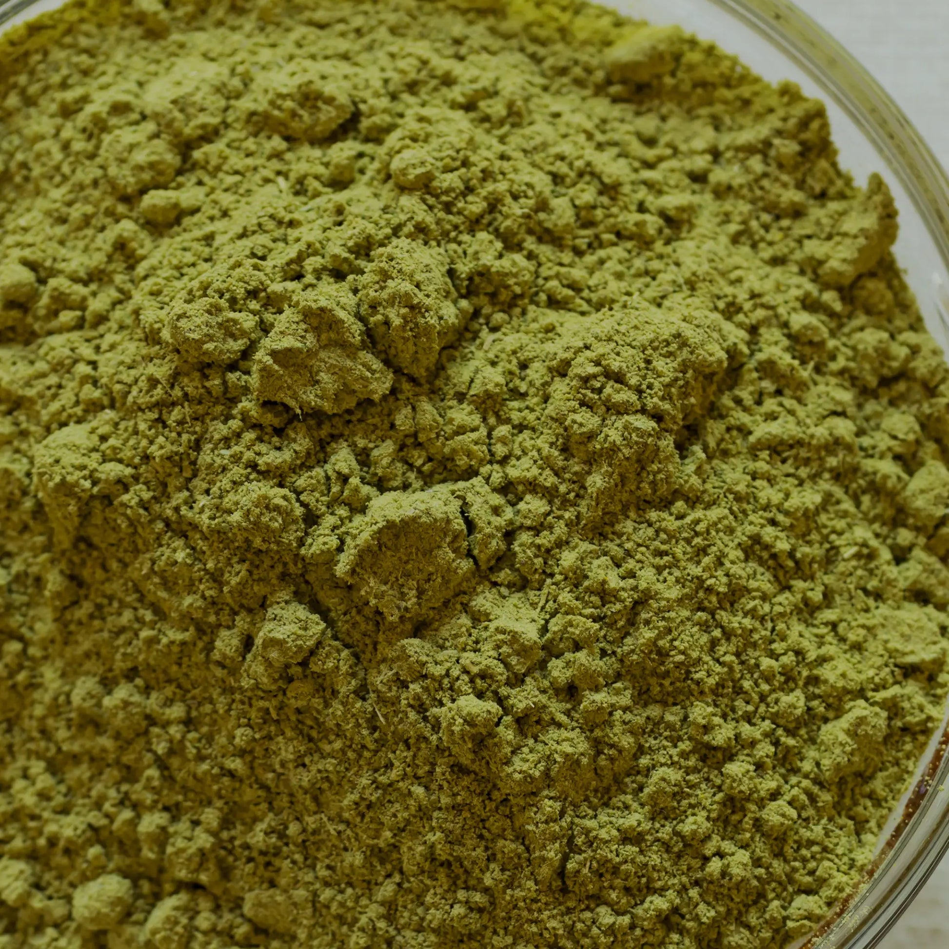 Close-up of me time green henna powder in a clear container