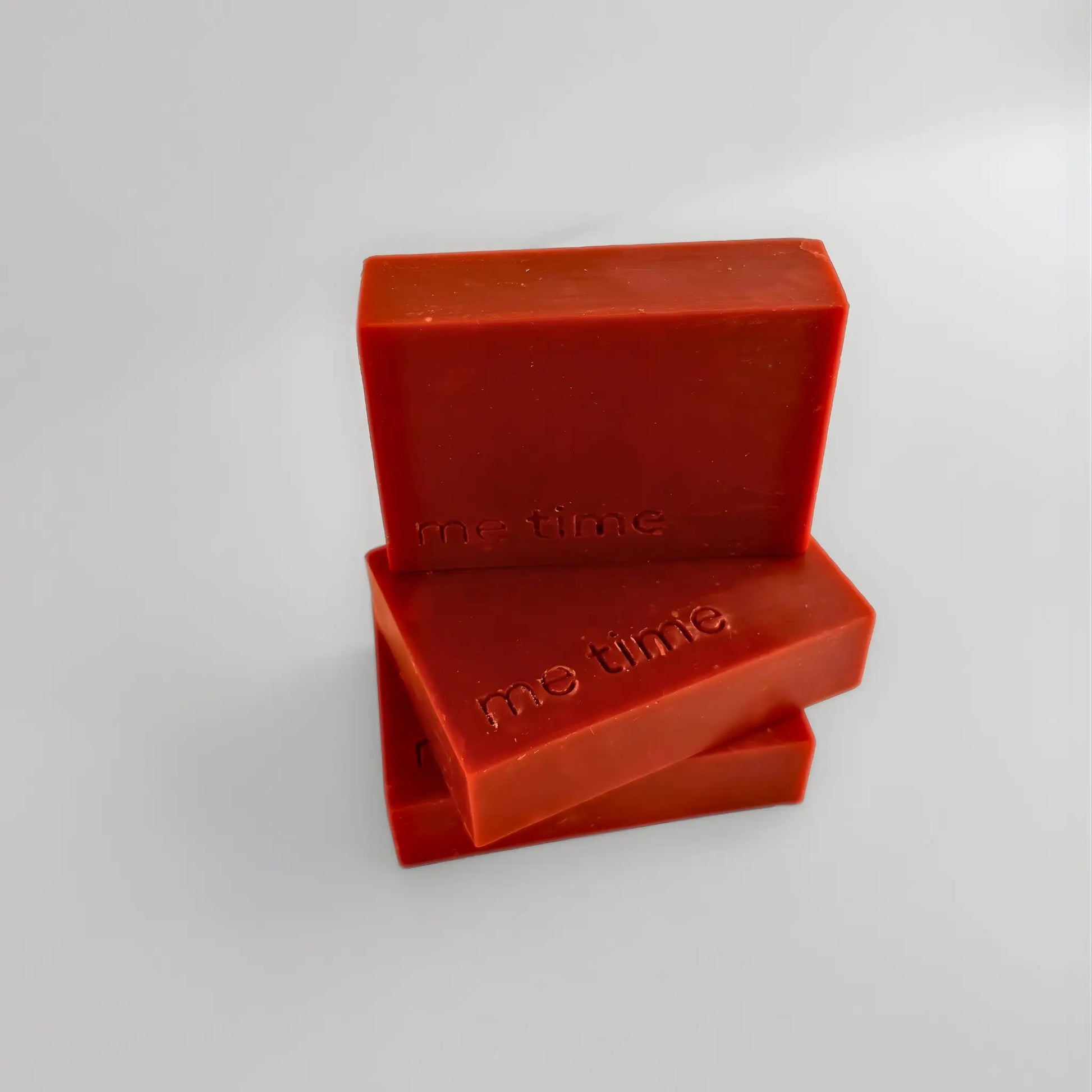 Two red rhubarb soap bars with 'the time' branding on a light gray background