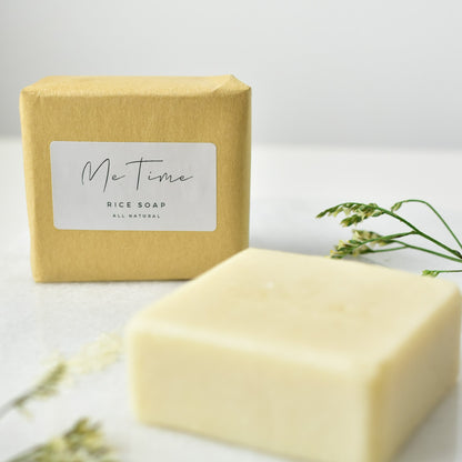 Handmade natural artisan soap bar with rice and rice water, featuring gentle exfoliation and deep hydration properties. The soap is crafted with palm oil, olive oil, coconut oil, and castor oil, with a natural rice fragrance.